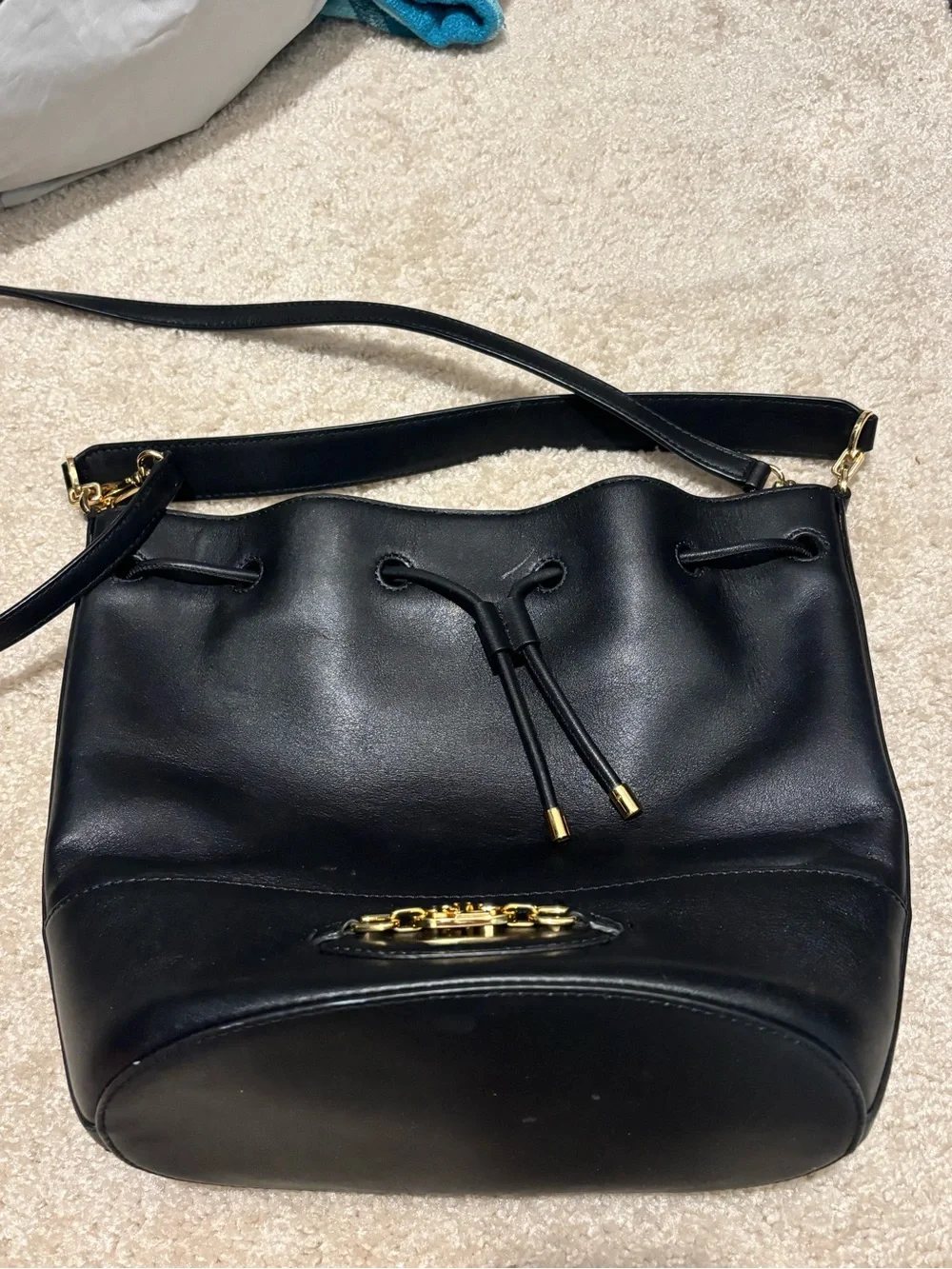 black leather drawstring bucket bag with shoulder or crossbody strap